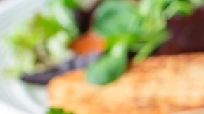 Mesa con mantel marrón con diferentes platos con hamburguesas de carne vegana y papas fritas