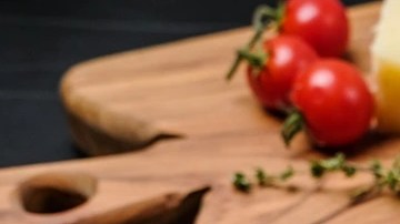 Plato negro con pappardelle con salsa de queso azul y calabaza en una mesa gris