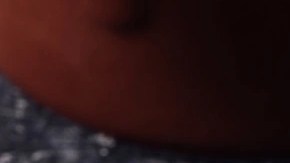 Una arepa rellena de carne mechada o desmechada sobre una mesa de color negro