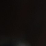 Manzanas cubiertas de chocolate negro sobre una mesa negra y decoración de Halloween