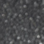 Recipiente transparente con paté de vermut sobre una mesa gris