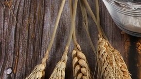 Un pedazo de crepa de pizza sobre un plato blanco en una mesa de madera