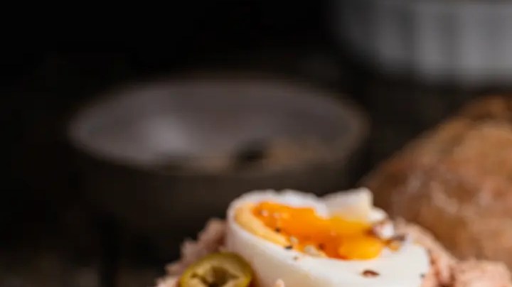 tostada de atún en pan integral redondo con huevo y tomate