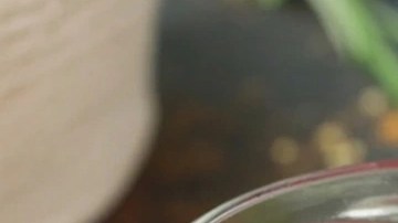 Frascos de vidrio con mermelada de frutos rojos, sobre una tabla de madera y cubiertos encima