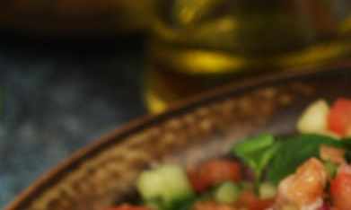 Ensalada de pepino con limón en una cazuela sobre una mesa gris